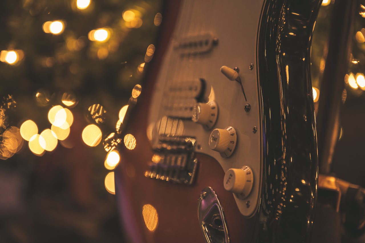 Elegant electric guitar with glowing bokeh lights creating a musical ambiance.